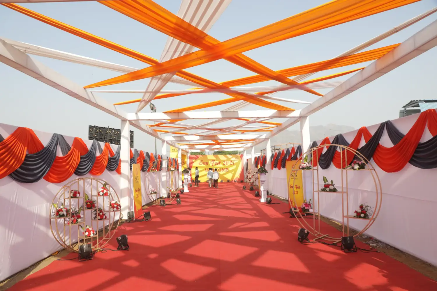 Man and woman speaking on stage at night with blue lighting